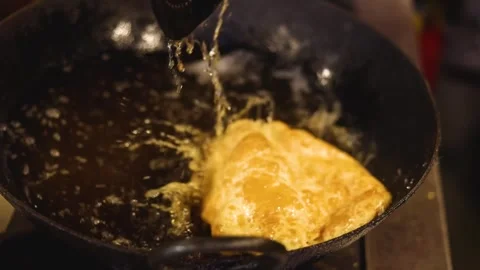 Indian bread or bhatura being fried in oil Stock Footage 297932064