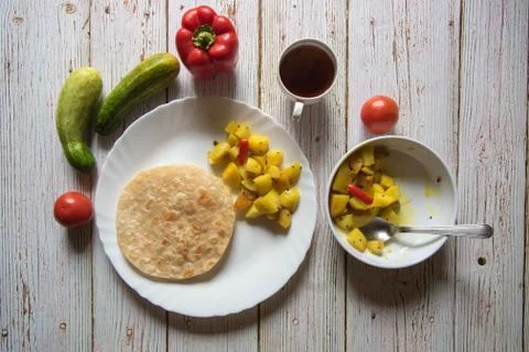 Indian bread puri or paratha with cooked vegetables Stock Photos