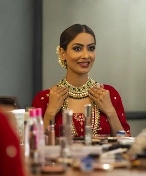 Indian Bride during the makeup session looking in to the mirror	 Stock Photos