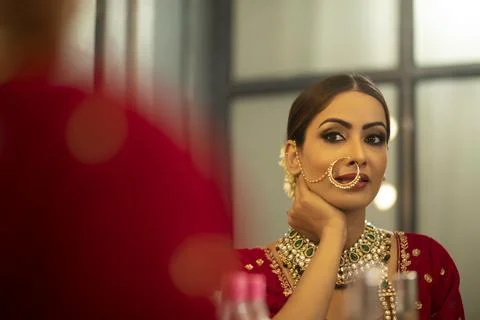 Indian Bride during the makeup session looking in to the mirror	 Stock Photos