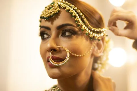 Indian bride during the makeup session	 Stock Photos
