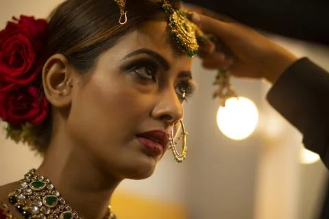 Indian bride during the makeup session	 Stock Photos