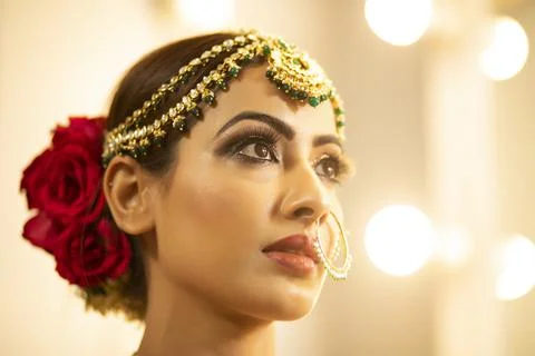 Indian bride during the makeup session	 Stock Photos