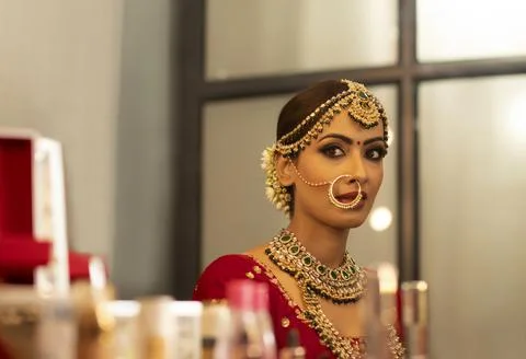 Indian bride during the makeup session	 Stock Photos