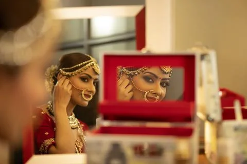 Indian bride during the makeup session	 Stock Photos