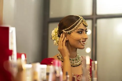 Indian bride during the makeup session	 Stock Photos