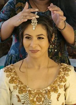 Indian bride getting ready during wedding preparations Stock Photos