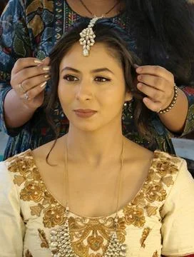 Indian bride getting ready during wedding preparations Stock Photos