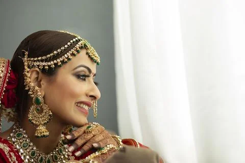 Indian bride looking out of window	 Stock Photos