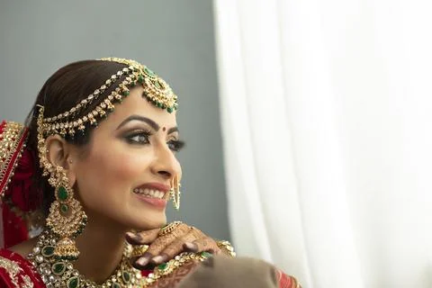 Indian bride looking out of window	 Stock Photos