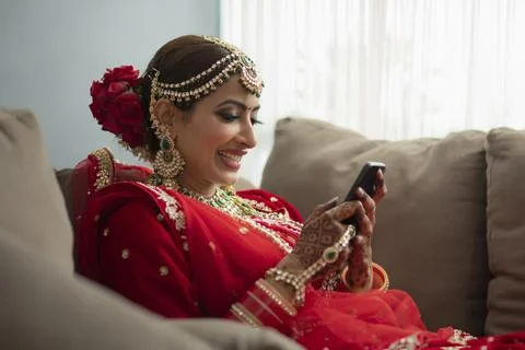 Indian bride looking out of window	 Stock Photos