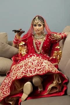 Indian bride relaxing on couch	 Stock Photos