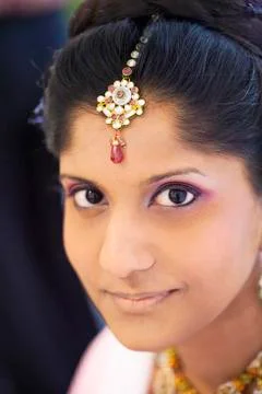 Indian bride wearing head jewelry Stock Photos