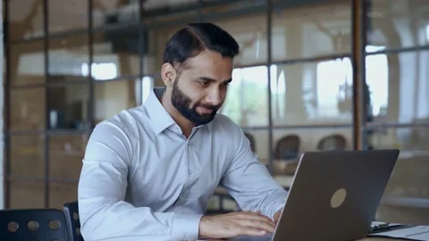 Indian business man using computer working in office doing online data analysis. Stock Footage 164101584