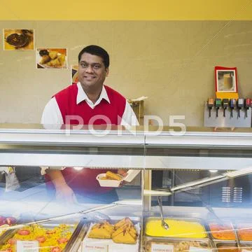 Indian Businessman Behind Restaurant Counter