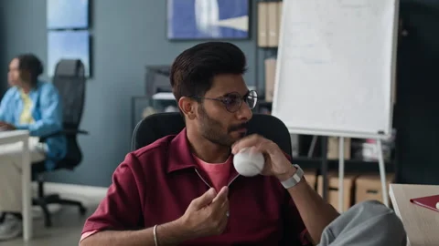 Indian Businessman Brainstorming While Playing with Baseball in Office Stock Footage 338336273
