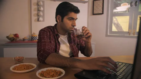 Indian businessman having alcohol while working on his laptop at night - stre... Stock Footage 197349072