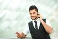 The indian businessman stand by business center work with the phone Photo