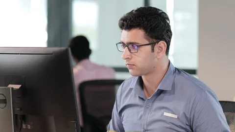 An Indian businessman using a computer to complete an important business task Stock Footage 88062086