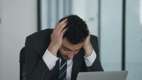 Indian businessman using labtop being worried after receiving news about work Video stock 236596944