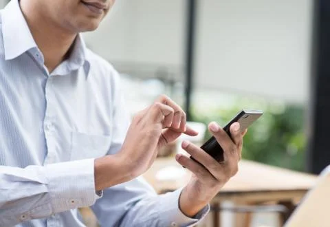 Indian businessman using smartphone while having lunch Stock Photos