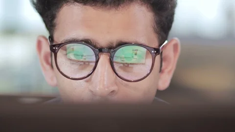 An Indian busy businessman wearing eyeglasses working on the computer in India Stock Footage
