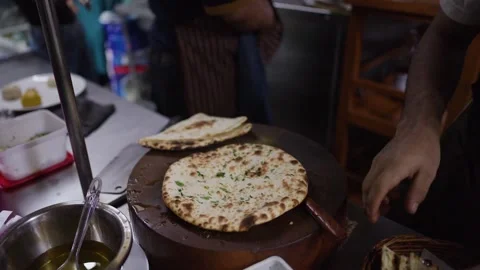 Indian Chef Brushing Butter on Fresh Garlic Naan Flatbread Stock Footage 345783579