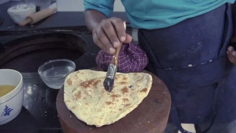 Indian chef cutting garlic naan Stock Footage 70468853
