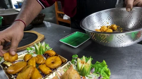 Indian Chef Plating Fried Pakora and Samosa Appetizers in Bangkok Kitchen Stock Footage 342693036