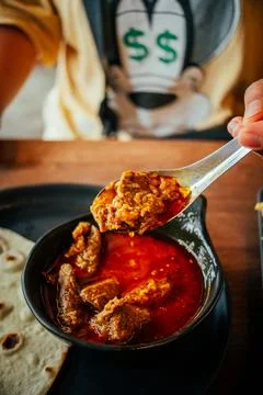 Indian Chicken Curry with Roti Flatbread and Toasted Bread on Wooden Table Stock Photos