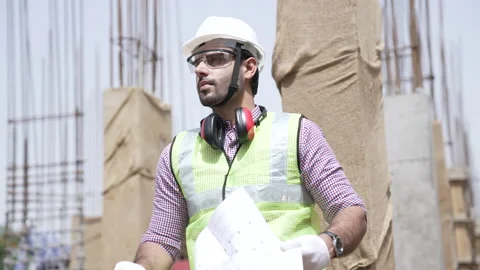 Indian construction engineer check drawings plan on site. 動画素材 162014705