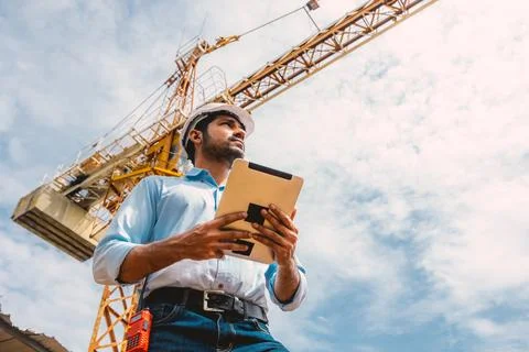 Indian construction engineer worker construction site control operation. Fo.. Stock Photos