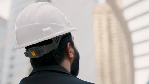Indian construction manager with white helmet observes architecture elements Stock Footage 311932178