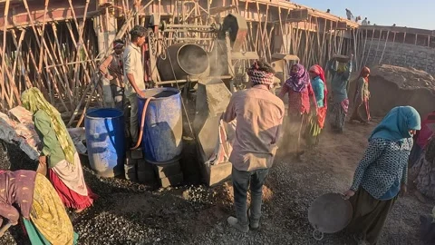 Indian Construction Site Laborers Using Concrete Mixer Machine for Building Stock Footage 337790157
