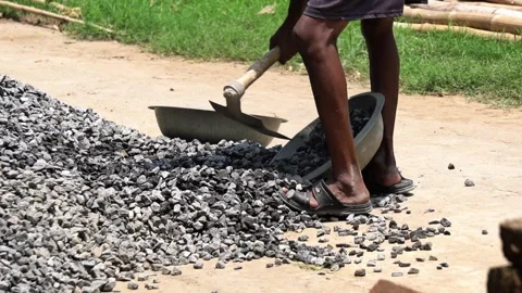 Indian Construction Worker Scooping Crushed Gravel with Hoe Close Up. Stock Footage 337850532