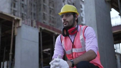 Indian construction worker seeing outside from construction building. Видео 161876382