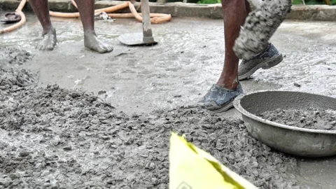 Indian Construction Workers Mixing Wet Cement Concrete by Hand at Building Site. Stock Footage 337850385