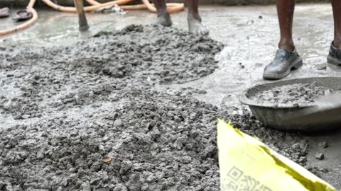 Indian Construction Workers Pouring Wet Cement Aggregate Mix on Rooftop. Stock Footage 337850274