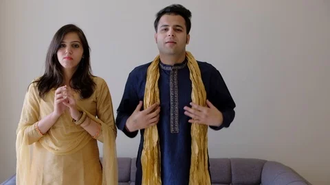 Indian couple adjusting themselves for a shoot listening to camera person off ca Stock Footage 100631079