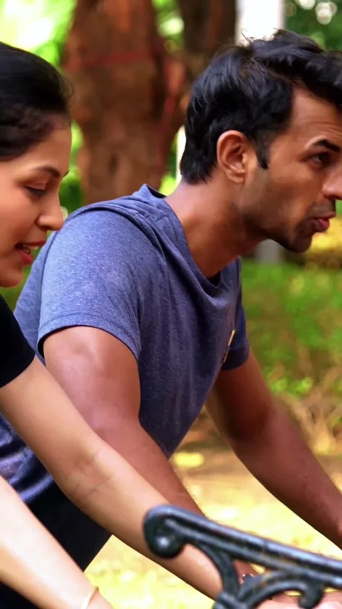 Indian couple doing pushups together on park bench maintaining fitness Stock Footage 342843693