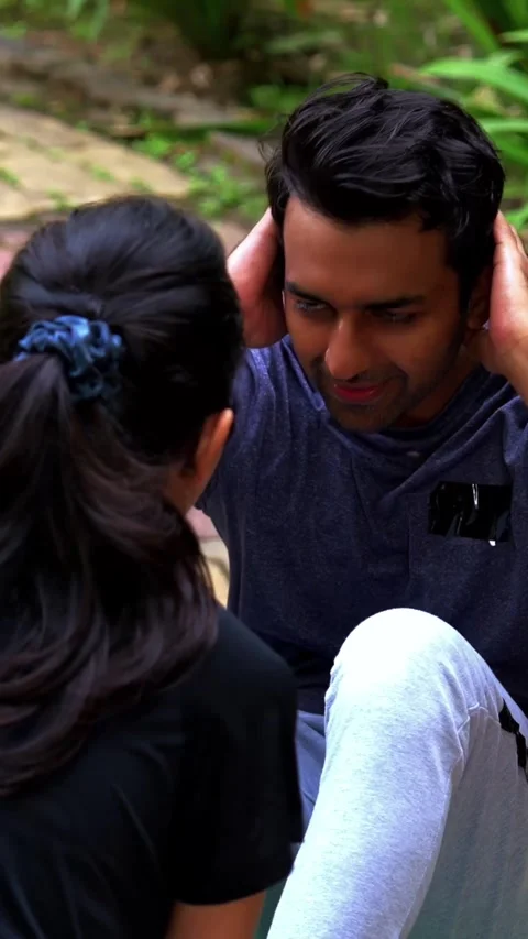 Indian couple doing sit-ups together on mat in outdoor park in the morning Video stock 342843724