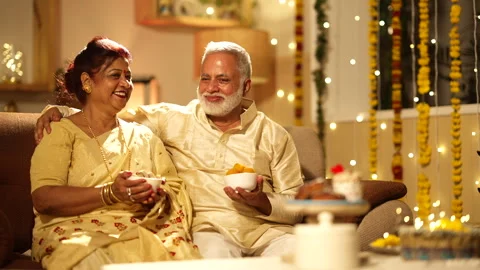 Indian couple looking camera by holding sweets during diwali Stock-Footage 252592030