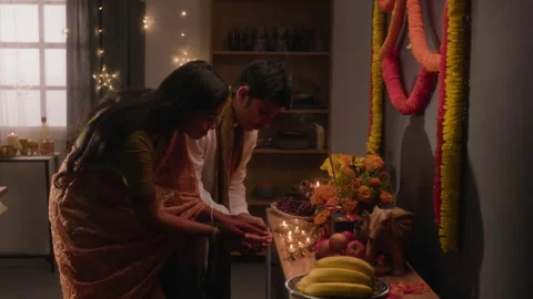 Indian Couple Praying Together in Front of Traditional Altar Stock Footage 344950194