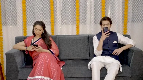 Indian couple using phones individually Stock Footage 249398920