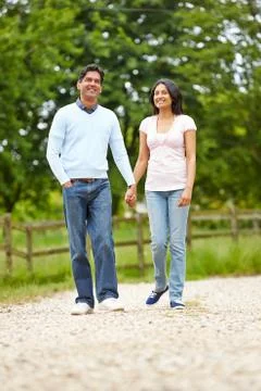 Indian couple walking in countryside Stock Photos