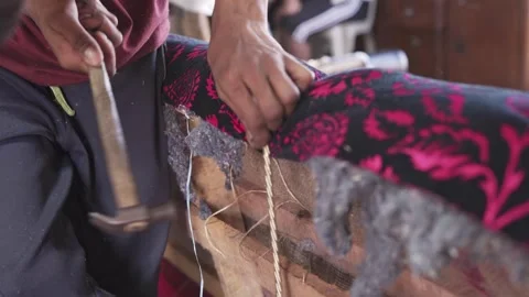 Indian craftmaker building a sofa couch structure using an hammer inside a Stock Footage 242983433