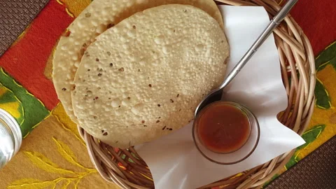 Indian crispy cracker Padadum appetizer fried rice flour with sour tamarine.. Stock Footage 239422863