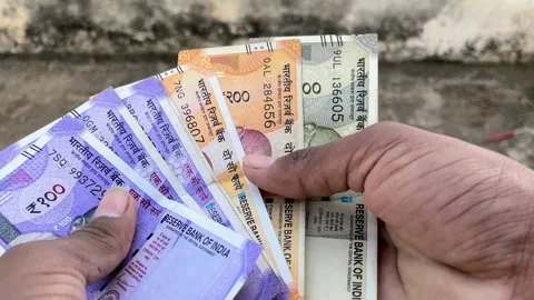 Indian Currency Notes in Hand Close Up | Showing 100, 200 and 500 Stockbeeldmateriaal 319447834