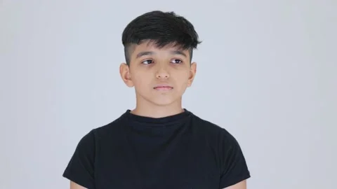 Indian cute boy sad feeling he is wearing black dress in white back ground Stock Footage 159595087