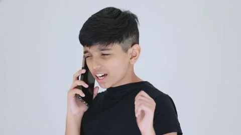 Indian cute boy talking with his smartphone and smiling he is also curious h Stock Footage 159595331